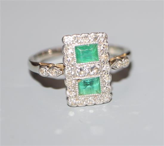 An Art Deco white metal, emerald and diamond set double cluster tablet ring, size K.